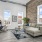 a living room with a stone wall and natural lighting from surrounding windows