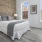 brick wall and high ceilings in bedroom with city views